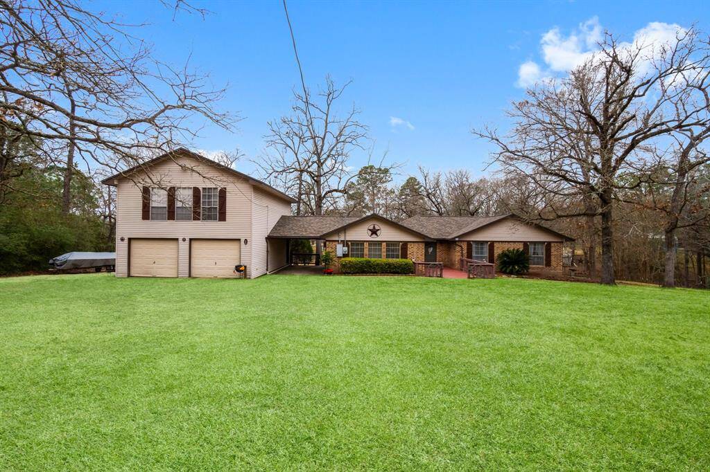 Privacy on over .80 of an acre with woods on the left side and fence on the right side. Guest quarters with two bedrooms & one large full bathroom above the two car oversized garage with a side entrance through the atrium/ covered carport.