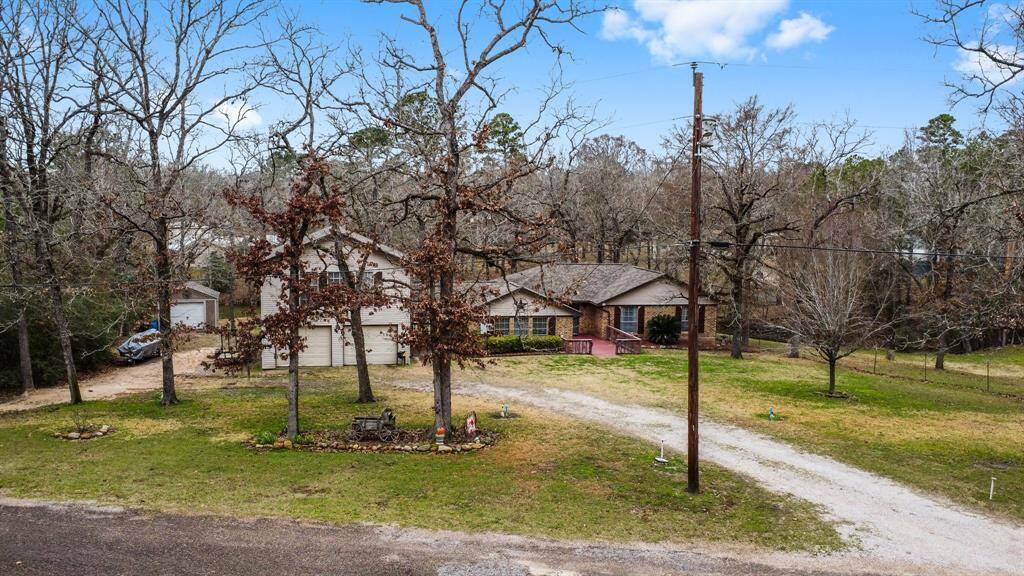Overview of home and front yard with mature trees