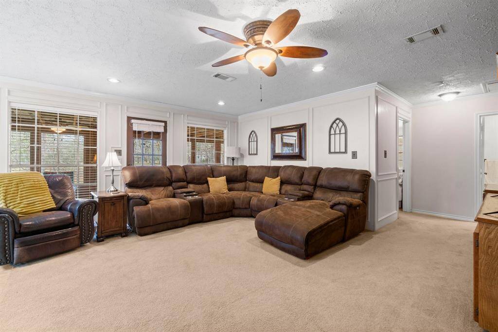 Large 6' windows throughout the home that are framed with elegant box trim paneled walls.  Living room flows to the three bedrooms and two full baths.