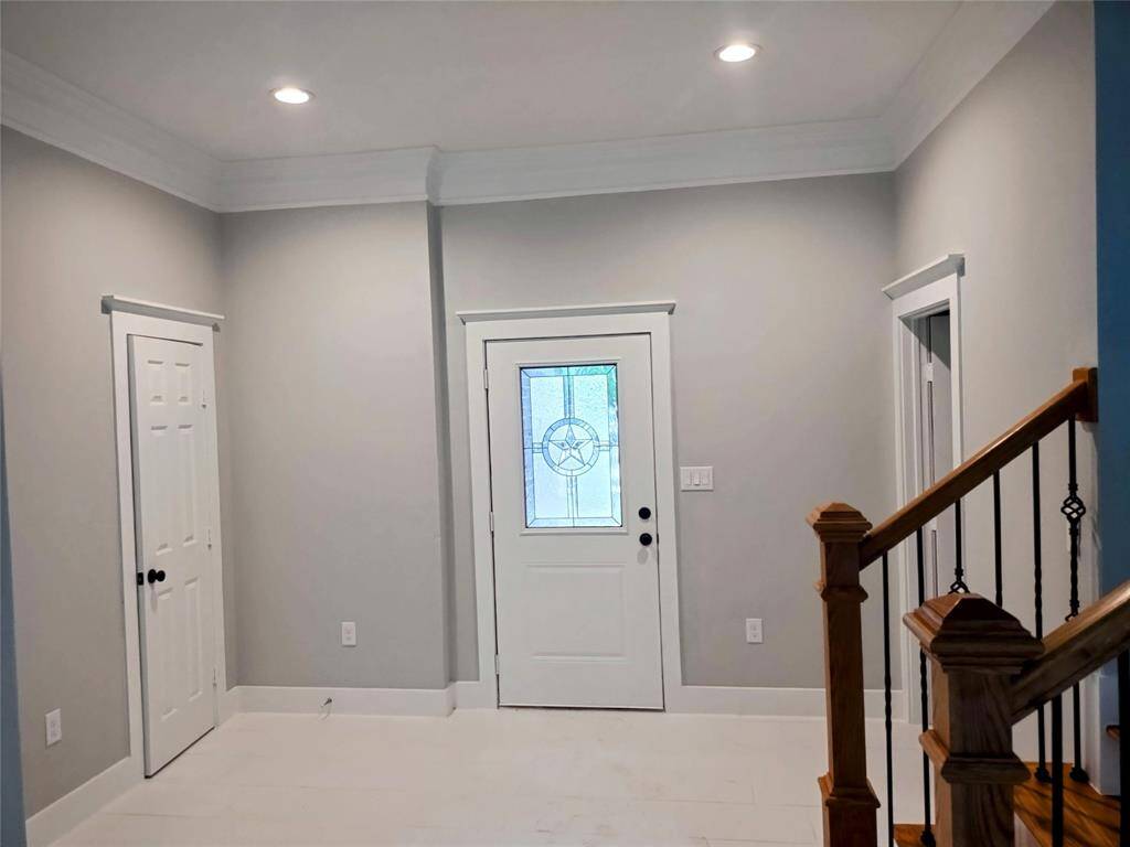 Entry with high ceilings and crown molding
