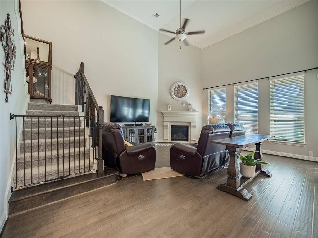 this view you have the stairs and the corner fireplace and the beautiful wood floors