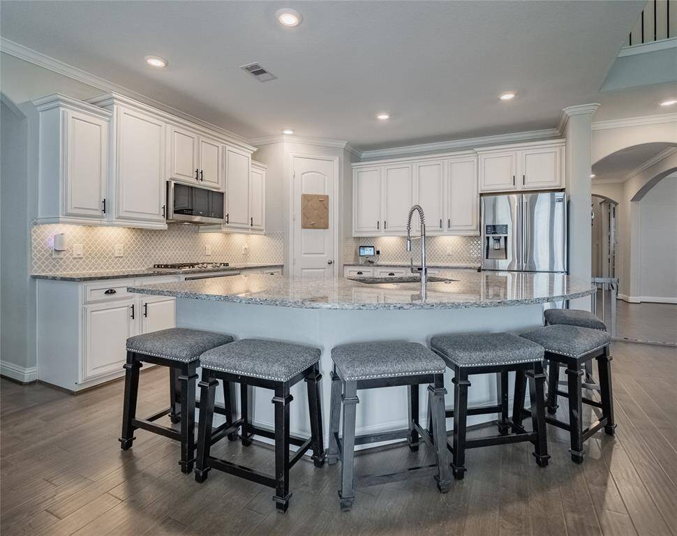 this is the oversized island with sink, this is an open floor plan lots of cabinet space and plenty of room for the bar stools, great area for entertaining