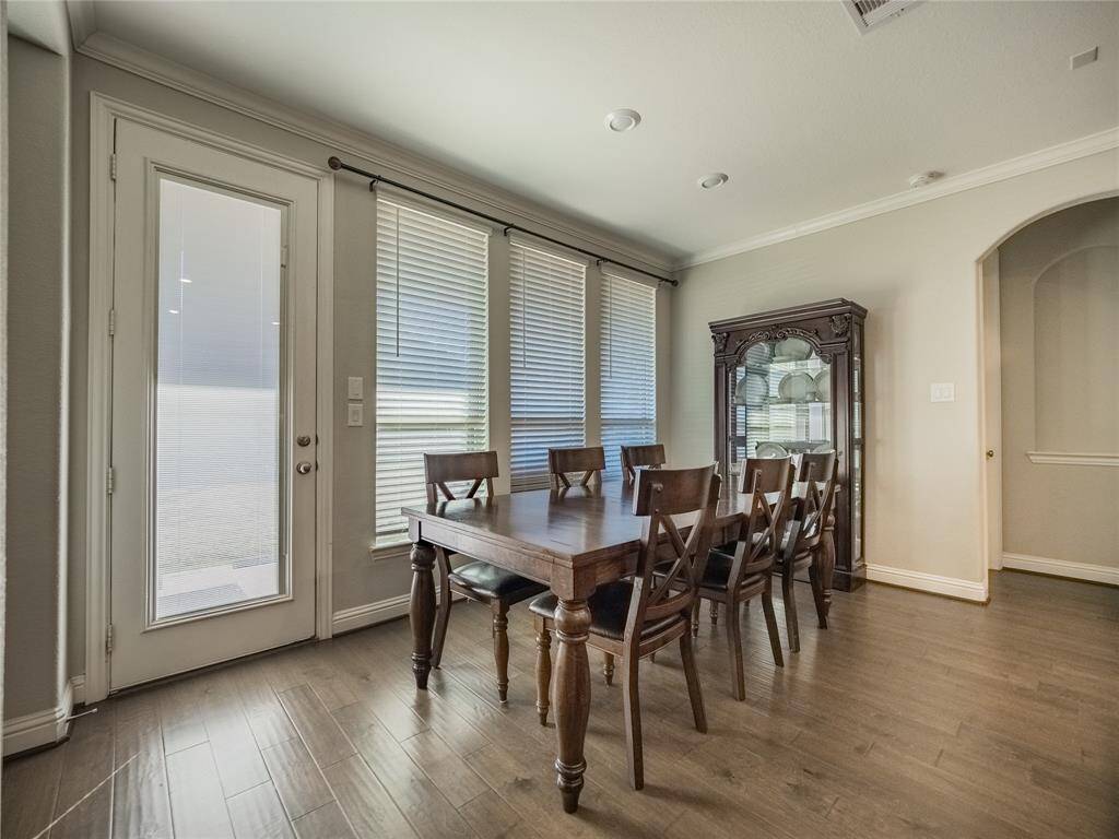 this is your breakfast area and the back door leading to your covered patio  and on the right is the entrance to the primary bedroom and bath