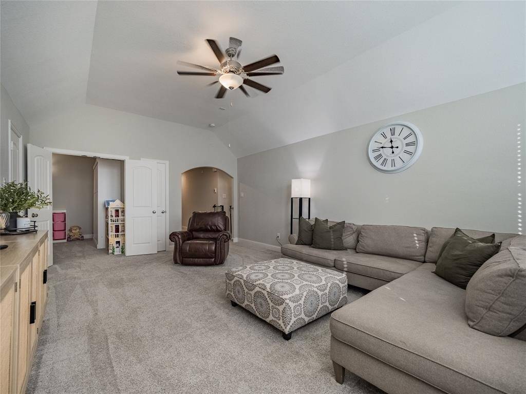 to the left of the workspace you have this oversized game room being used as a second family room and off the game room is a ture media room that is being used as a play room