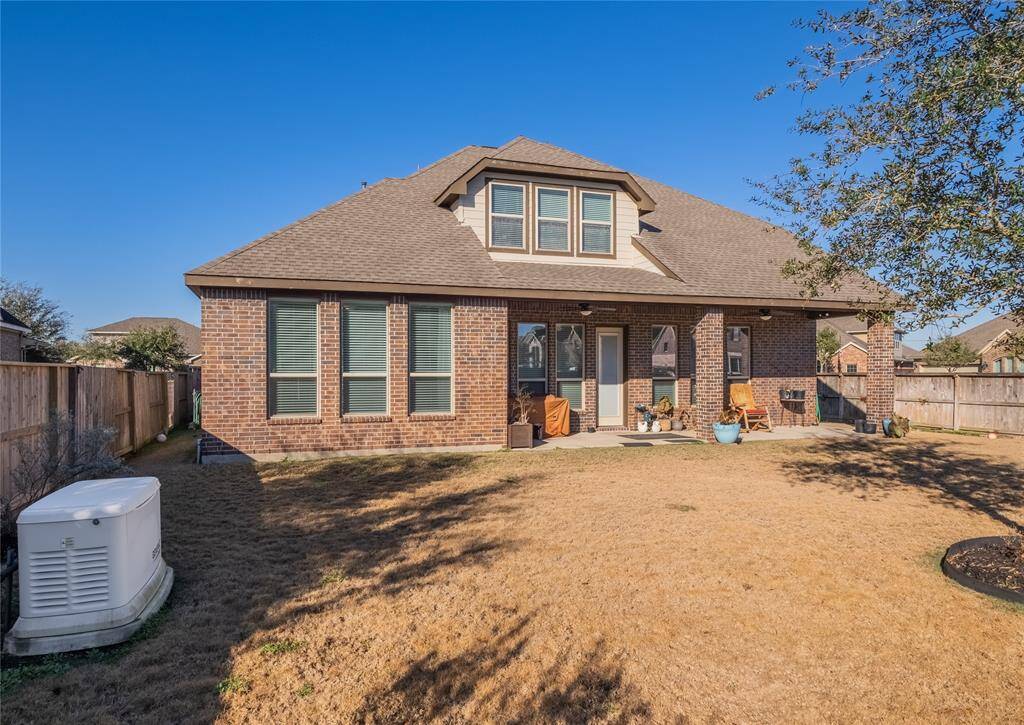 rear of the home covered patio oversized back yard and full house generator