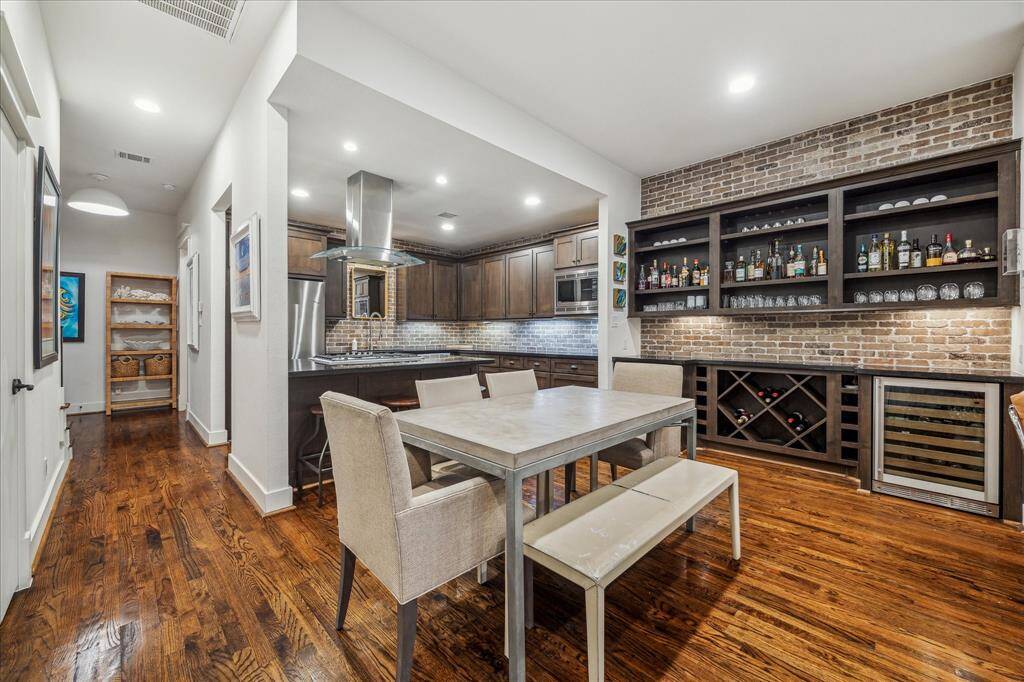 Dining Room: Sophisticated European design, Walnut-stained oak floors, soaring ceilings, and custom buffet-display built-ins.