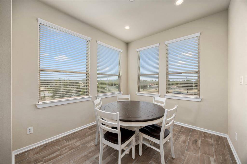 Dining space is wrapped in windows with views of the hustle and bustle of Bridgeland.