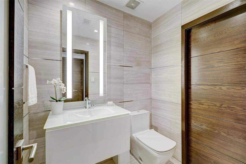 The Powder Room is a jewel box.  Wrapped in marble, it's conveniently located just off the Entry and even has one of the many storage closets you'll find throughout the home.