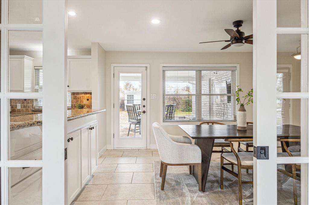 Elegant glass pocket doors separate the living room from the kitchen and dining area, providing a seamless flow between spaces while maintaining the option for privacy when desired.