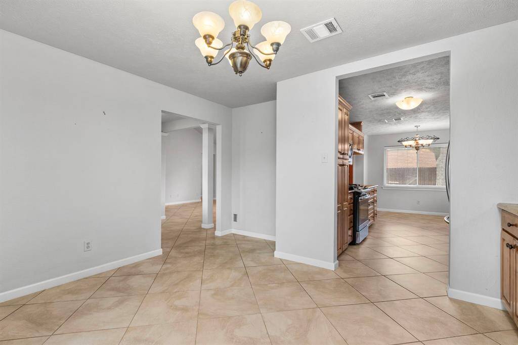Formal dining looking into kitchen to breakfast area.