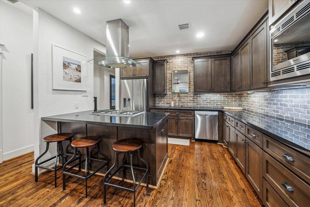 Kitchen: Kitchen takes center stage with unsurpassed ageless elegance with stainless steel Bosch 6-range gas cooktop, microwave, vent-hood/lighting, display cabinets, and dishwasher.