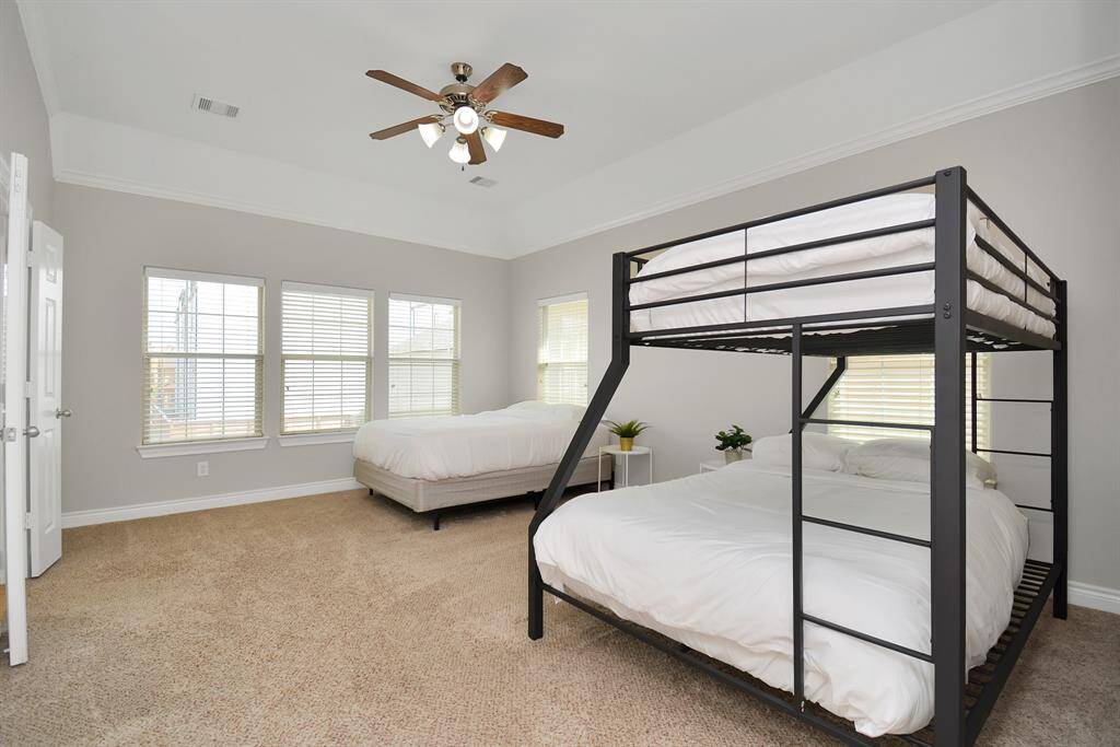 Primary Bedroom upstair with flush carpet, high ceiling that
