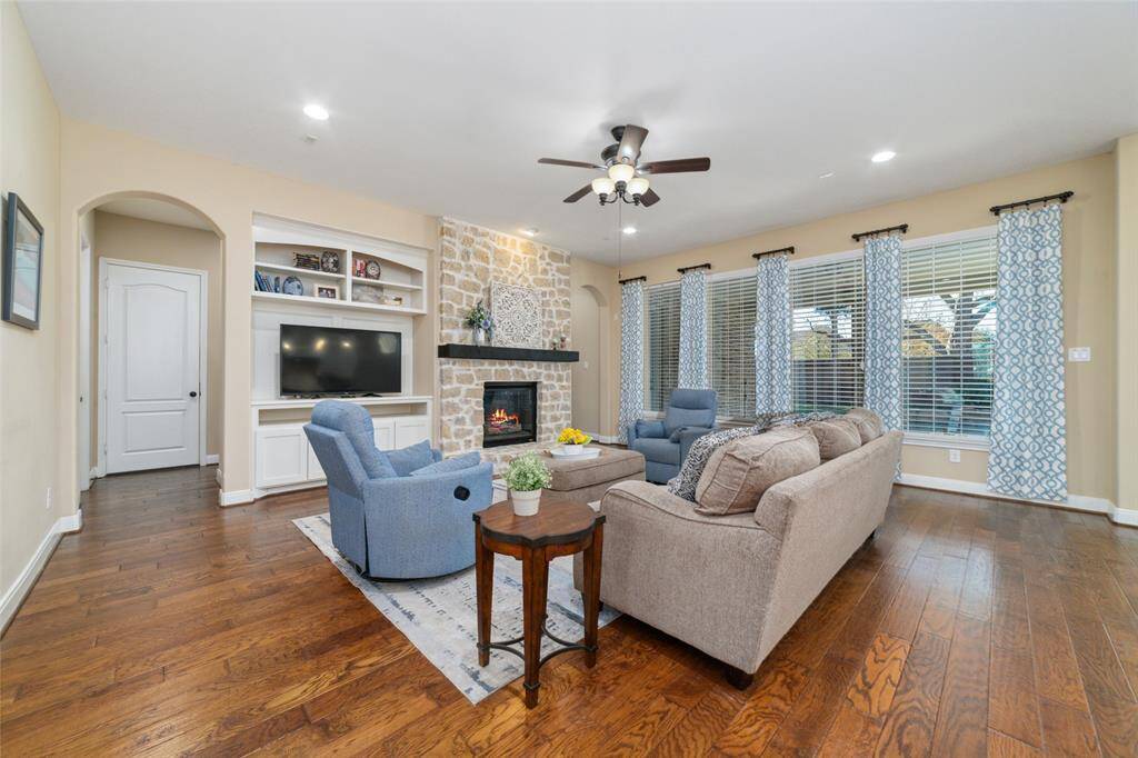 Enlarged family room with built in shelves and fireplace