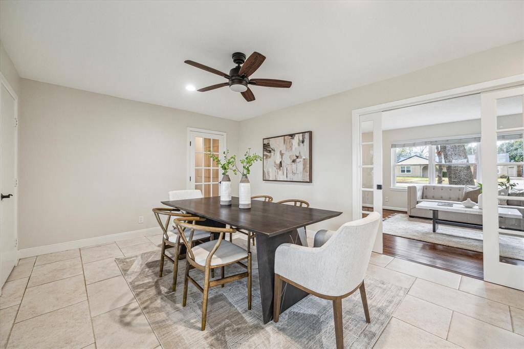 This spacious formal dining room is perfect for hosting special gatherings. With beautiful tile flooring, neutral paint, and plenty of space for your banquet table and sideboard, it's ready for both casual meals and big celebrations.