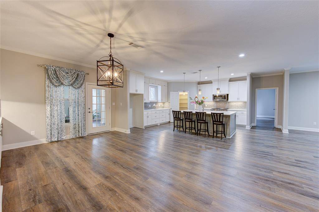 The extremely spacious dining room flows effortlessly from the gourmet kitchen, creating the perfect setting for both intimate dinners and grand gatherings.