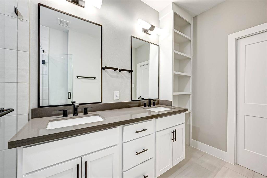 The primary bath has built-in shelves and private water closet.