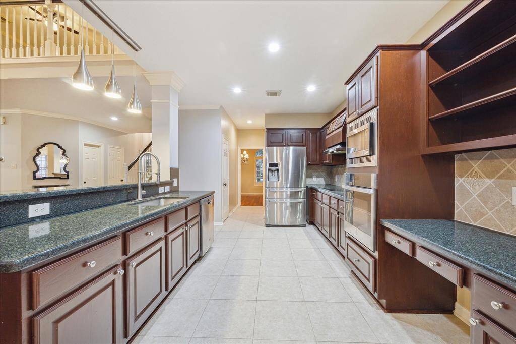 Kitchen features granite counters, stainless appliances, and plenty of cabinet storage.