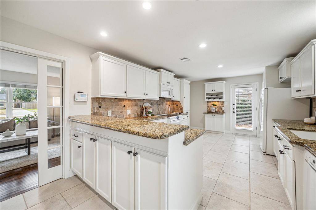 The kitchen is separated from the dining area by an extended raised bar. This is a great spot to grab a quick meal, serve snacks and drinks to guests, or add bar stools to create additional seating.