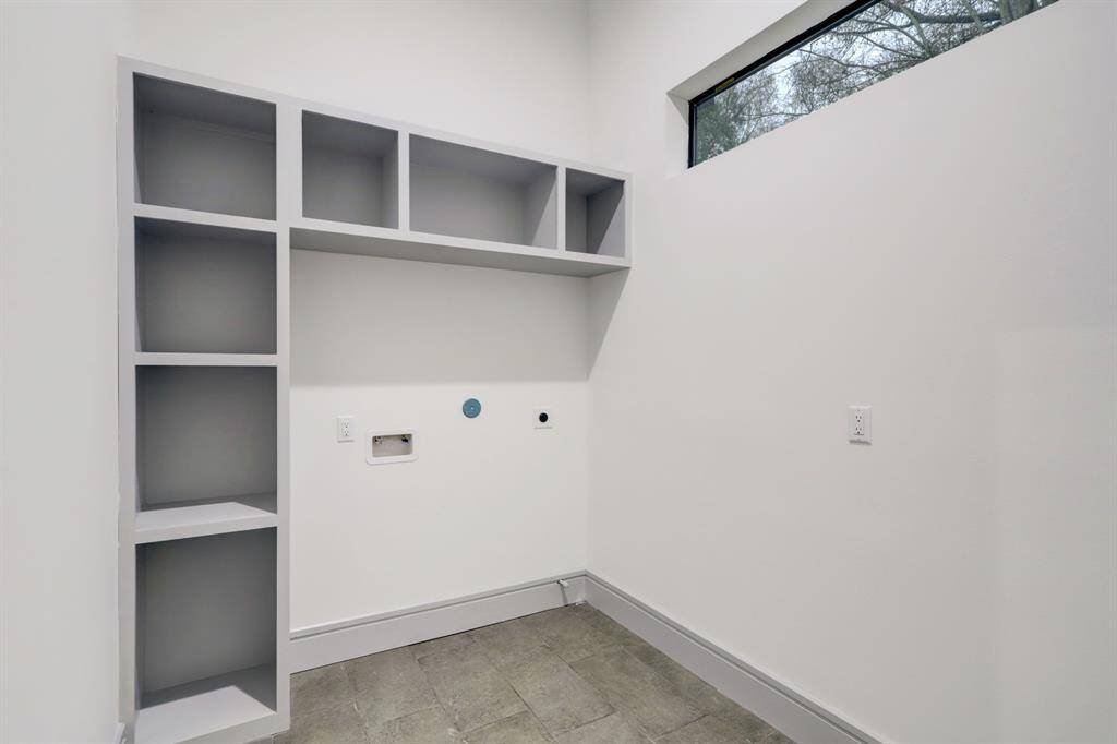Large utility room with custom built-ins, high ceilings and great natural light.