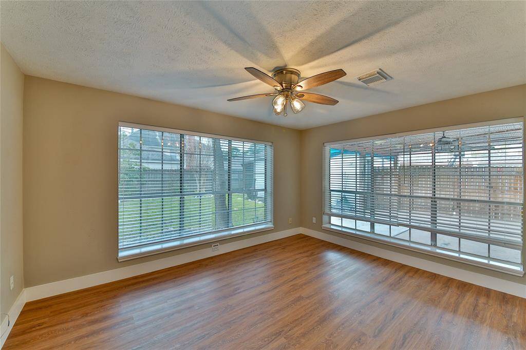 Sunroom facing back yard could be a game room, work-out room, craft room, and more