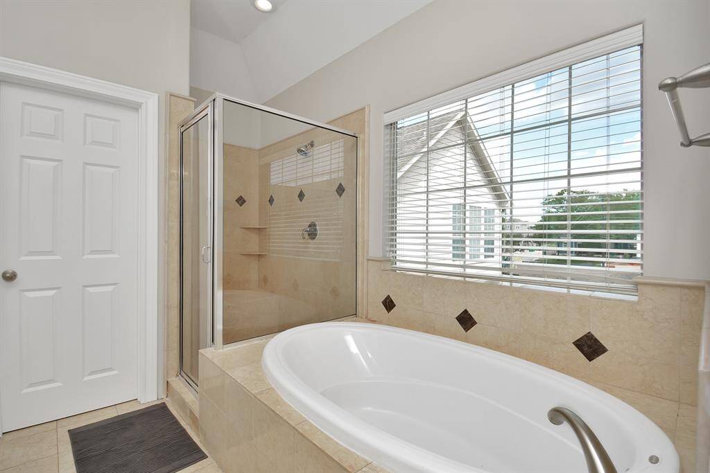 Primary bedroom with separate tub and shower