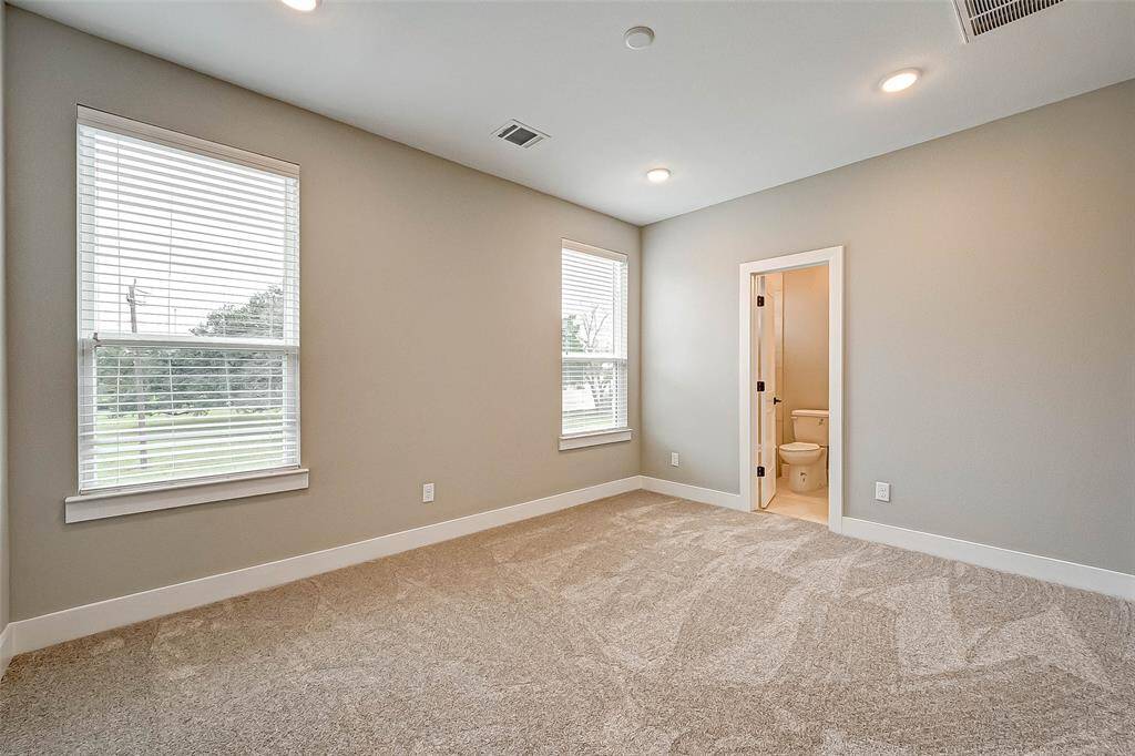 The 11x12 SF third bedroom has carpet, recessed lighting, walk-in closet, and 2" blinds.