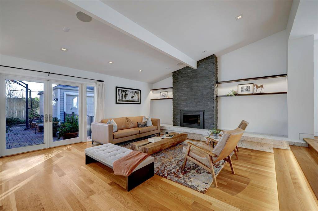 The back doors allow sunlight to stream in and open onto the charming patio.  Here you'll find access to the driveway and garage.