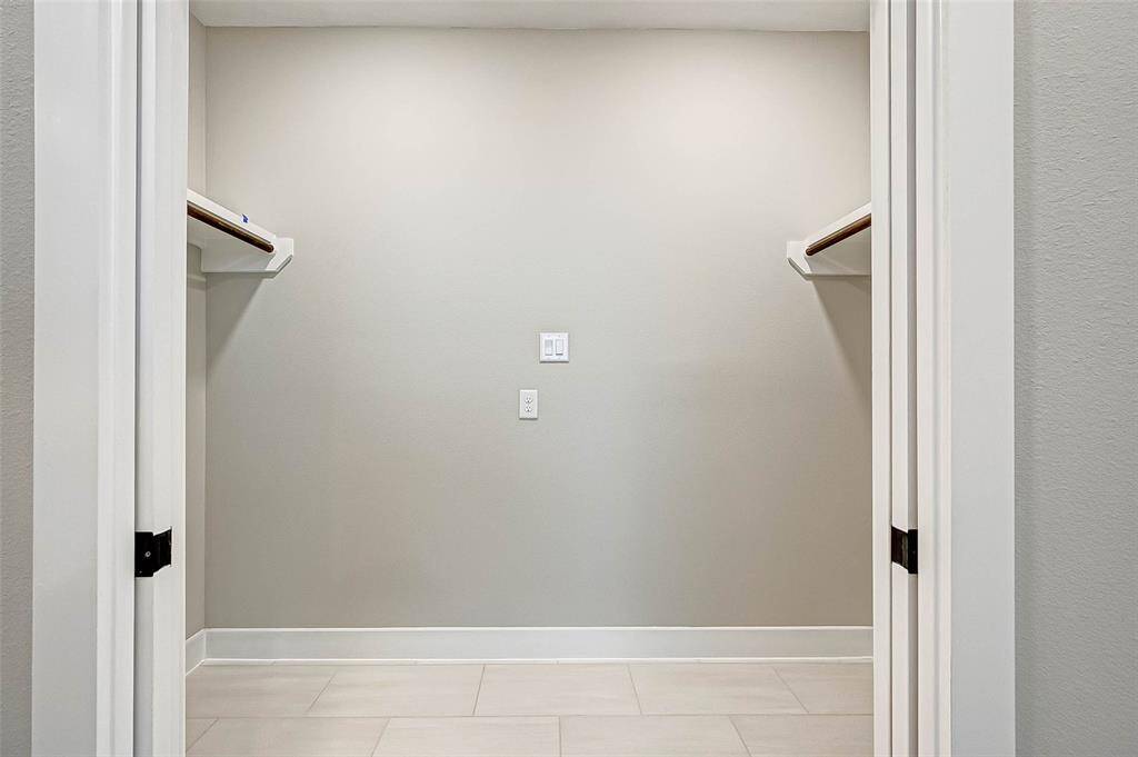 The 4x9 SF utility room has tile floor and built in shelves. Full size washer and dryer are being installed November 5th.