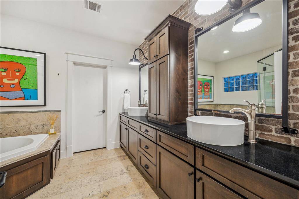 Master bathroom: Designed with the finest attention to detail, the Master Bathroom is extremely spacious and includes Cifial brushed Nickel hardware, custom (glazed) builtins, seamless glass shower, and (2) Nickel vanity sconces.