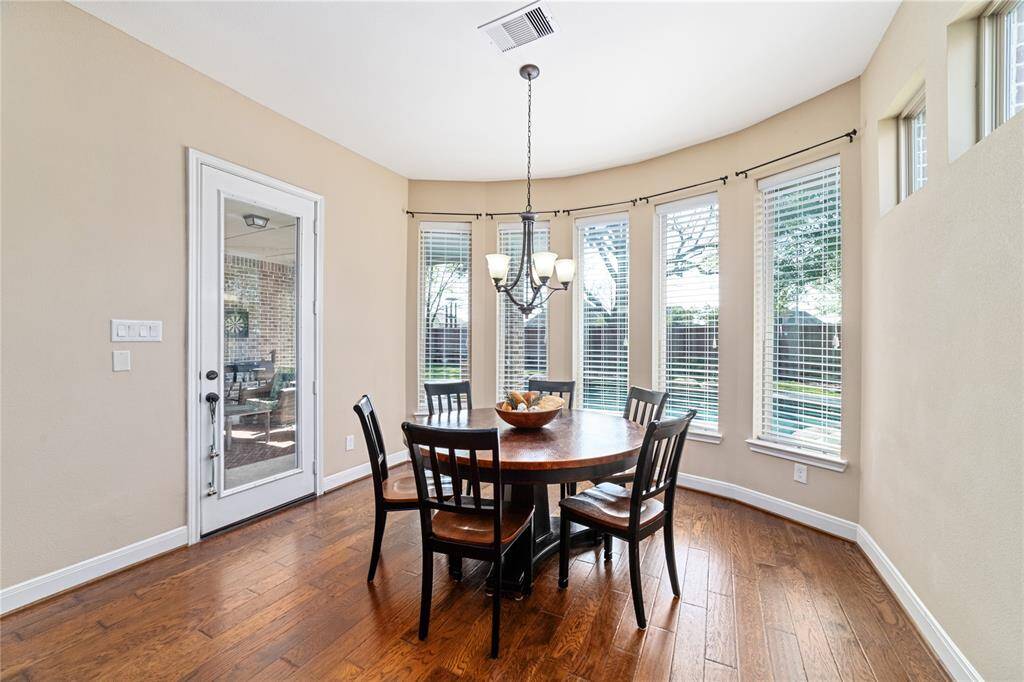 Breakfast area with wall of windows and doorway to the back patio