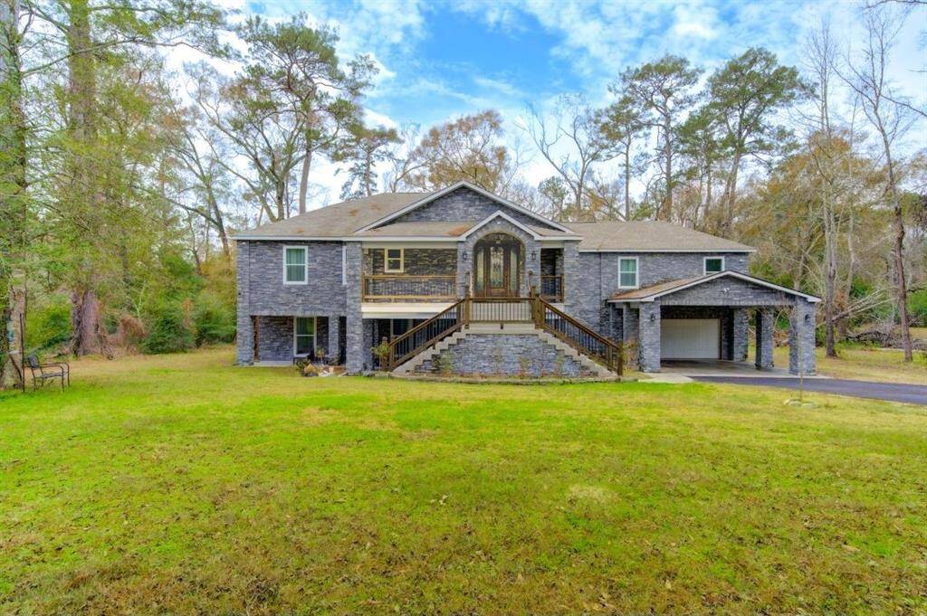 Nestled on nearly two sprawling acres of land, this gorgeous estate home is a private sanctuary, flanked by lush trees on both sides and along the back for an unparalleled sense of seclusion. A perfect blend of luxury and modern functionality, this residence boasts five spacious bedrooms—three upstairs and two on the main floor—designed for comfort and convenience.