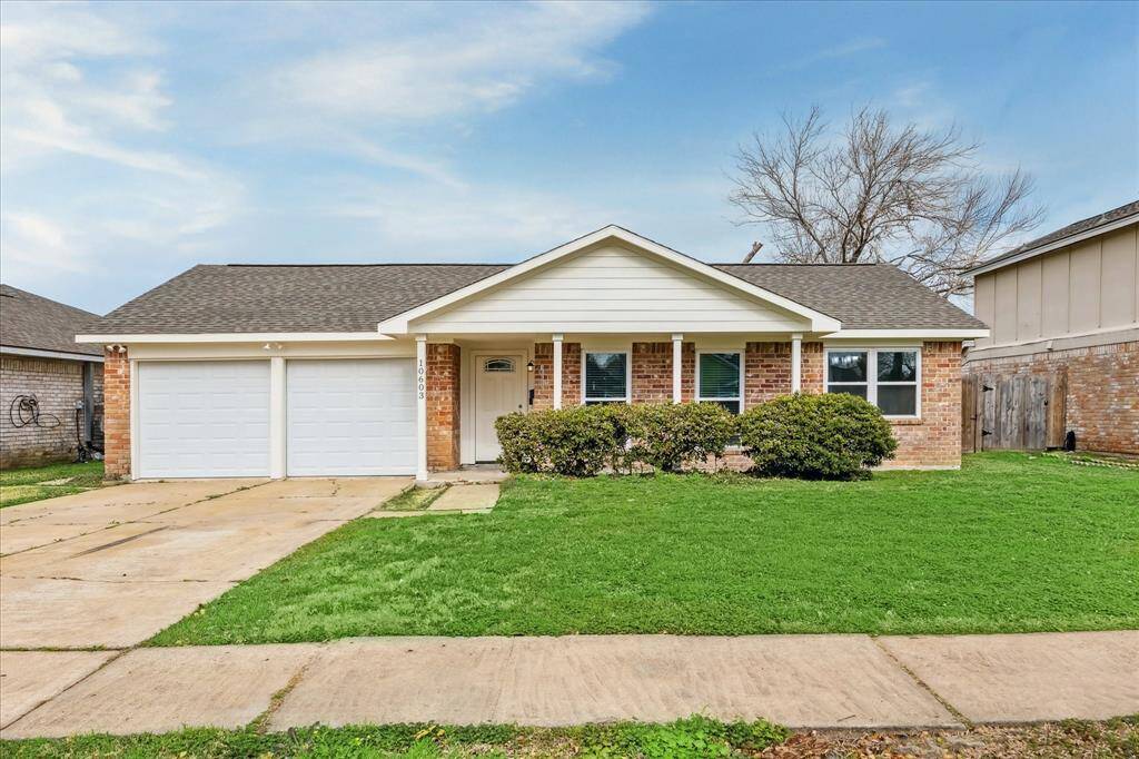 This photo shows a charming single-story brick home with a well-maintained lawn. It features a two-car garage, a covered front porch, and a simple, inviting exterior.