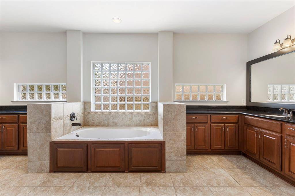 The primary suite is a dream on those busy mornings with both a large tub, separate shower and double vanities.