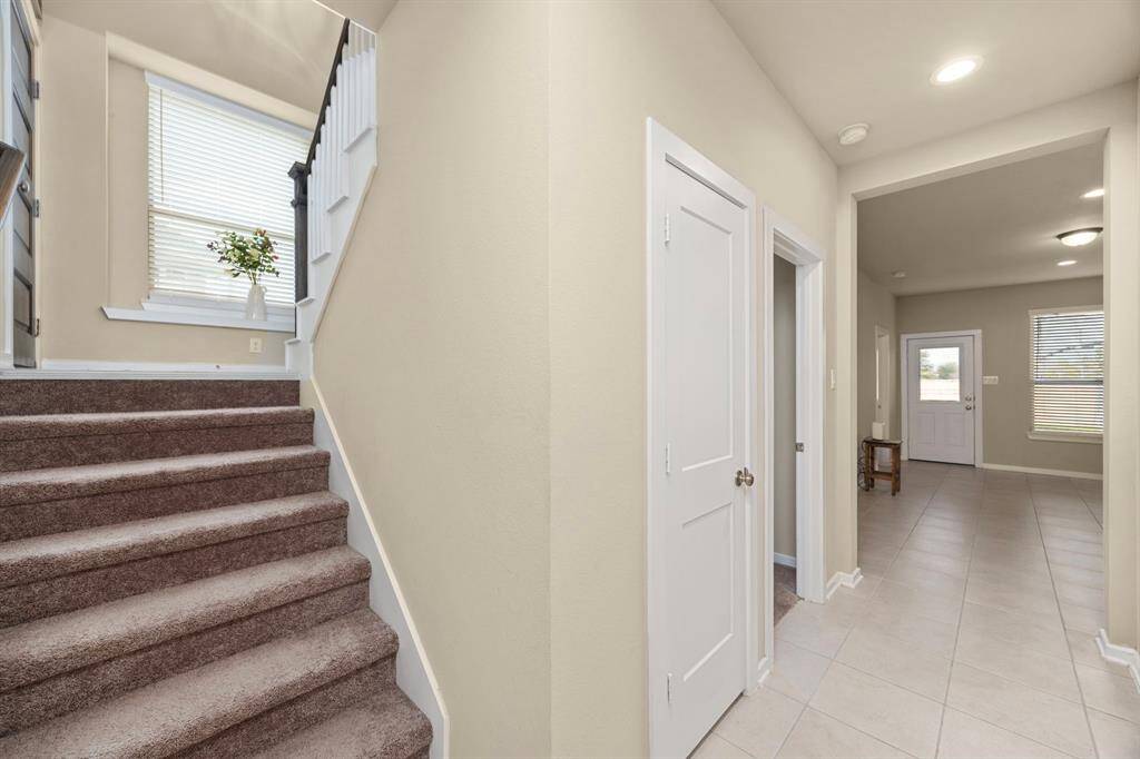 Travel to the ground floor to access the garage, gameroom, two additional bedrooms, bathroom, and backyard.