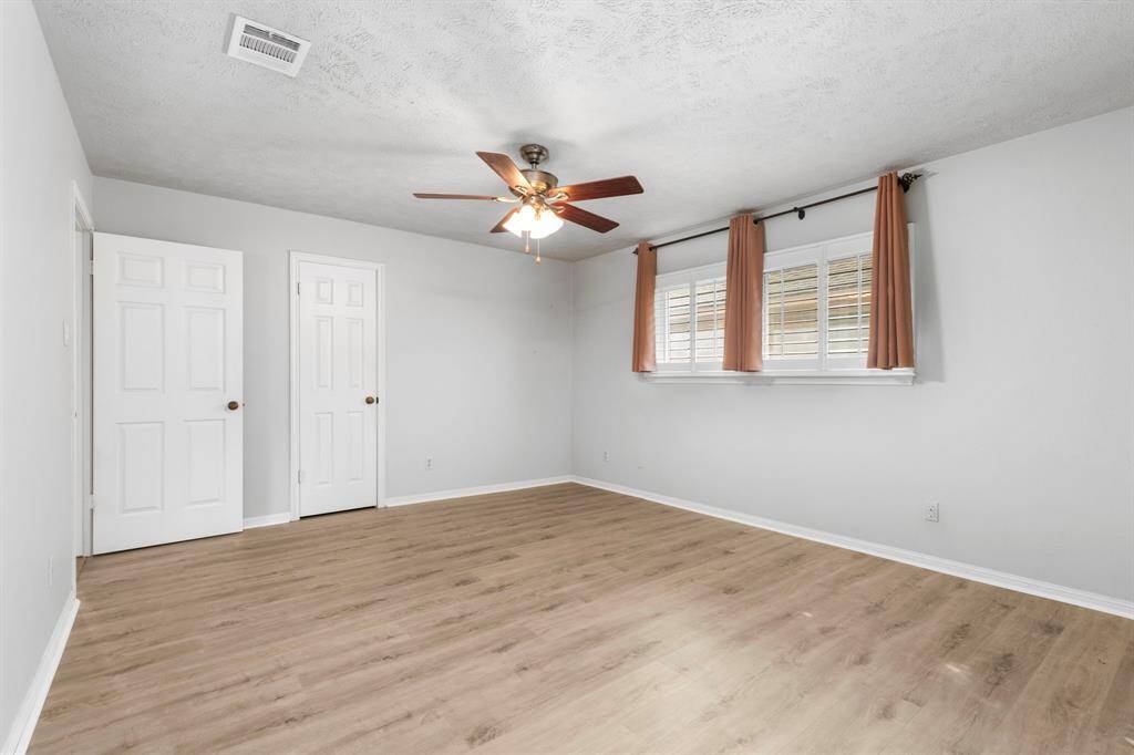 One of the two large closets in the primary bedroom, closed door seen here.