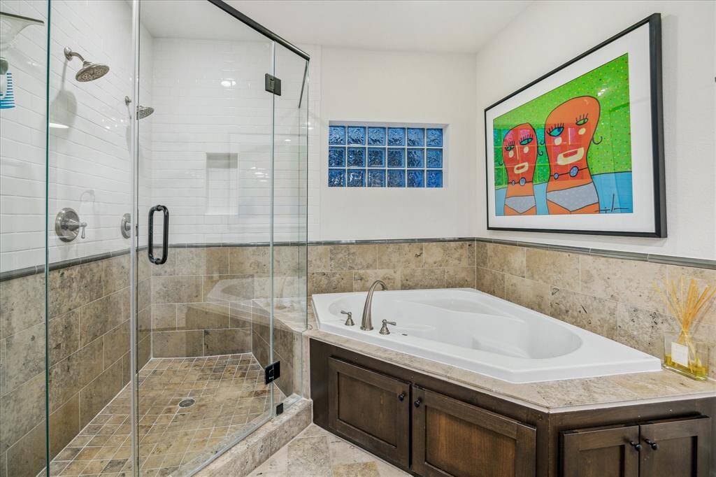 Master Bathroom: Private and prestigious master bath features double-wide seamless glass shower, over-sized walk-in closet, and Bain Ultra Jacuzzi tub.