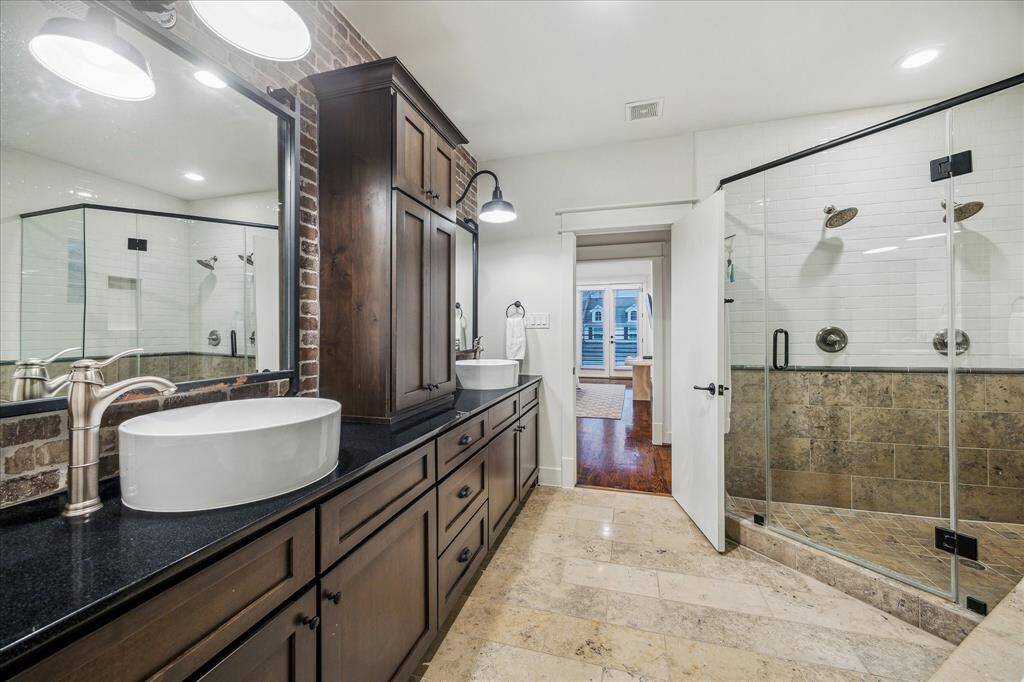 Master Bathroom: Kitchen: Crafted to transcend time & trend, the master bath spills over with collected elegance and comfort. Featuring designer twin-basin sinks, exquisite "Midnight"-granite countertops, over-sized custom mirrors, and impressive central toiletry armoire built-in.