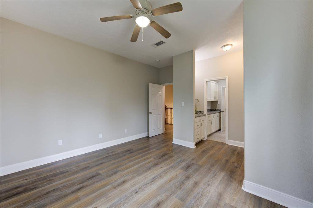 Another view of Bedroom Number 2 reveals to the right, a separate sink for this room only as well as an entryway and door leading to the Jack and Jill bathroom, seamlessly connecting to Bedroom Number 3.