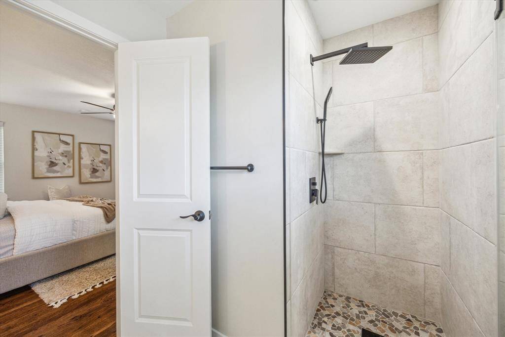 The primary ensuite bathroom also features a walk-in shower with beautiful tile work, upgraded fixtures, and a sleek frameless glass door for a modern touch.