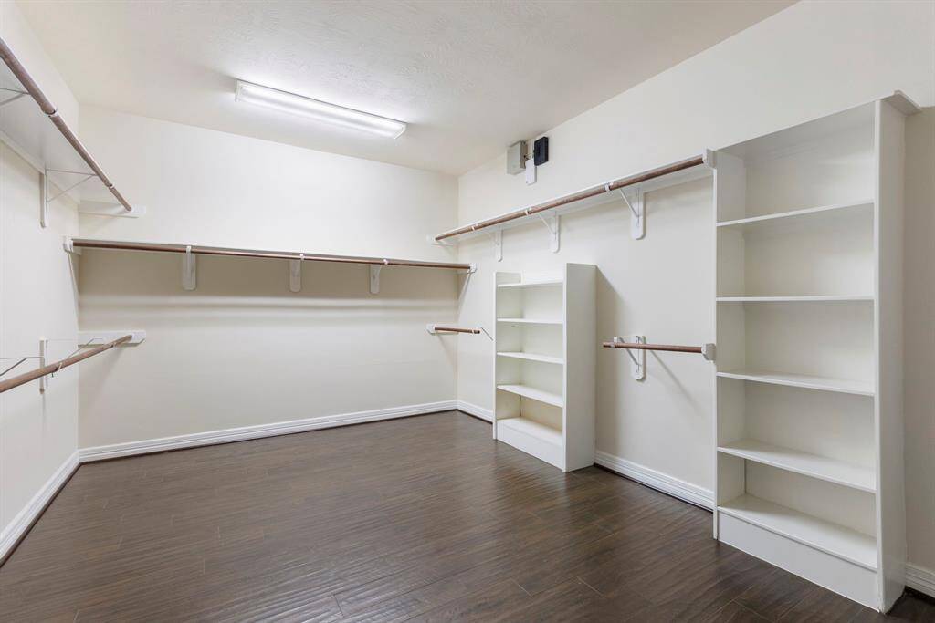 Huge walk-in closet with built-in storage in the primary bathroom.