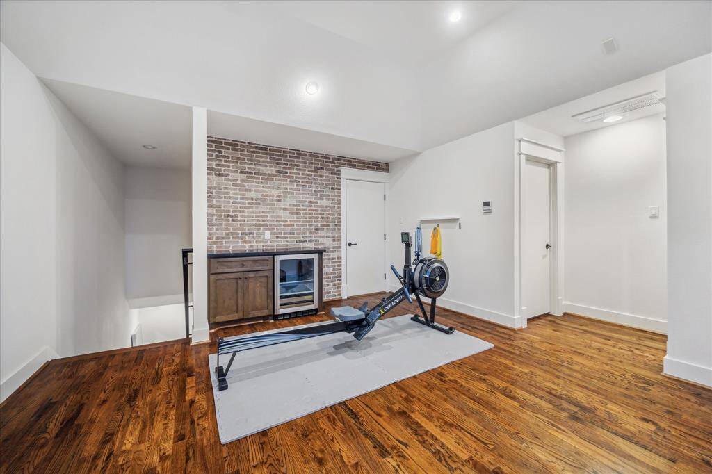 Game/ Media Room/ Bedroom #4: Grand Game/Media room with dramatic volume-vaulted ceilings, solid-wood floors throughout, custom builtins and juice bar. Luxuriously finished with fine millwork. Access to walk-in attic and full en-suite bathroom.