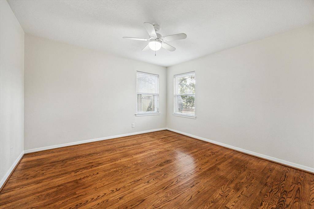 Your family and guests will rest comfortably in this spacious bedroom with hardwood flooring, a cooling fan, large closet, and easy access to an updated full bathroom.