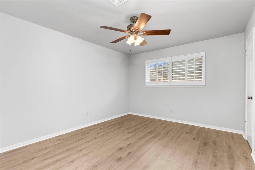 Secondary bedroom with plantation shutters and large closet.