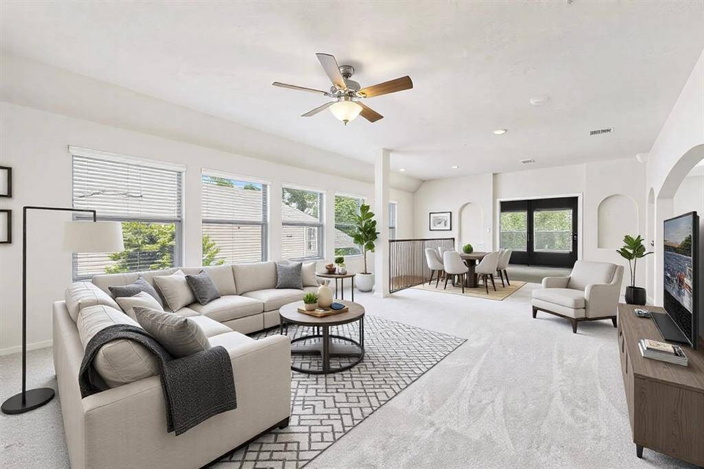 Double staircases lead upstairs to the expansive gameroom flooded with natural light, brand new carpet and ceiling fan. This room has been virtualy staged.