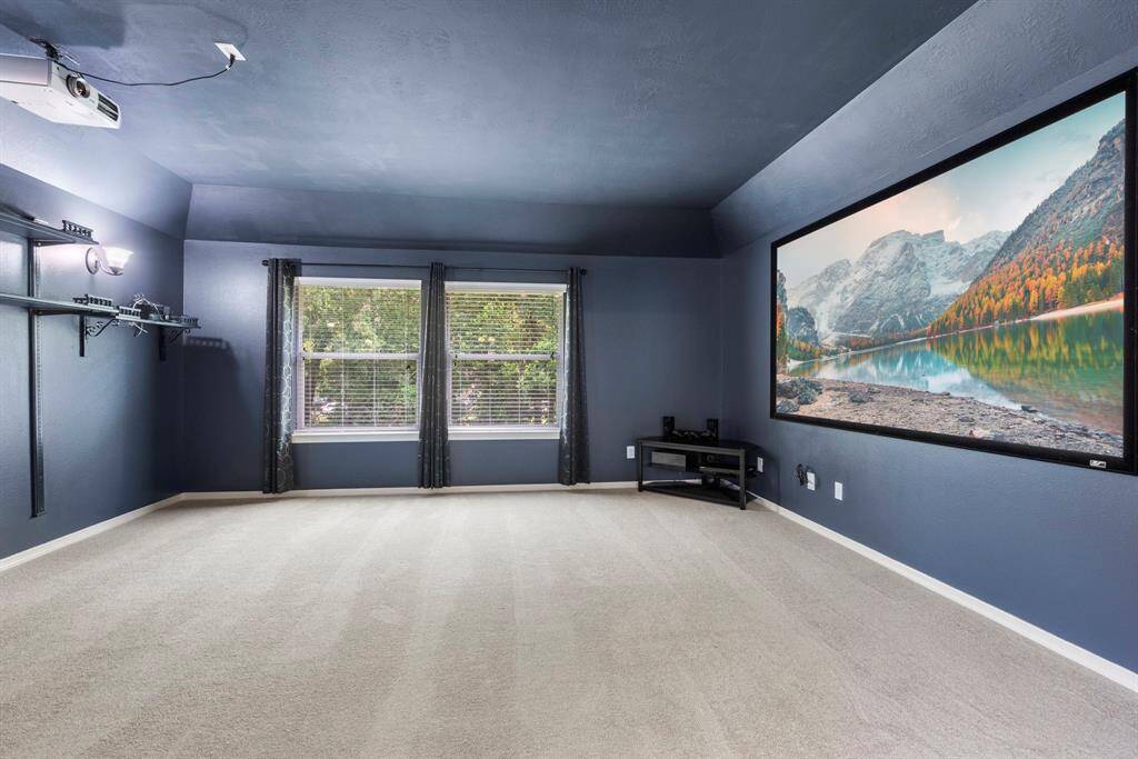 The media room provides the perfect ambience for family movie nights. You'll never need to go to the theater again! Bonus: Screen stays!