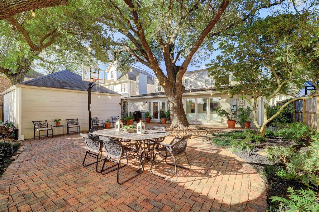 Another view of the pretty backyard and all the windows that allow natural light to stream into the home.