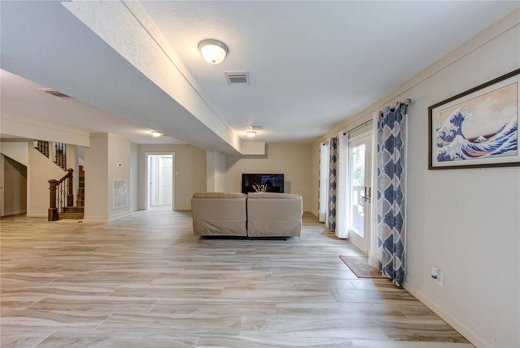 The downstairs living and dining room is extremely open and spacious. To the left, the elegant staircase leads to the second/main floor.