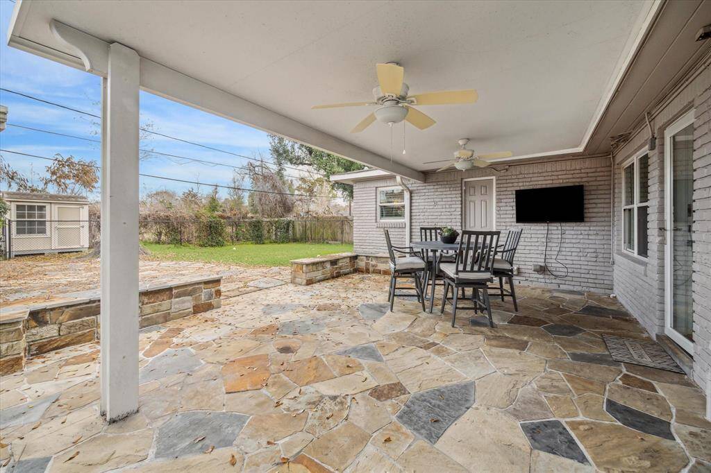 Whether you're hosting lively gatherings or seeking tranquility after a long day, this back yard paradise with a covered flagstone patio promises to provide the perfect space where memories are made and stress melts away.