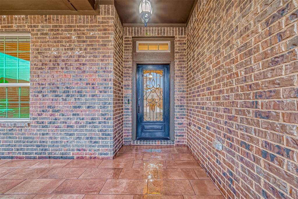 This welcoming entrance has a covered front porch & beautiful tile flooring!