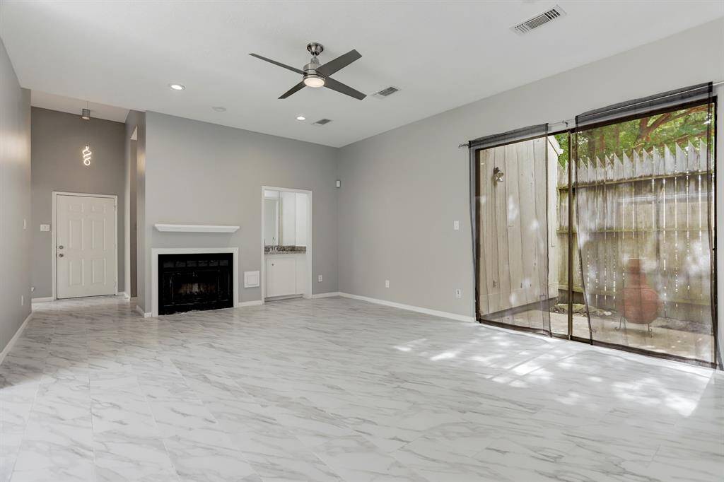 Space for entertaining with wet bar and private enclosed patio. Fireplace for those cozy evenings and high ceilings that are delightful